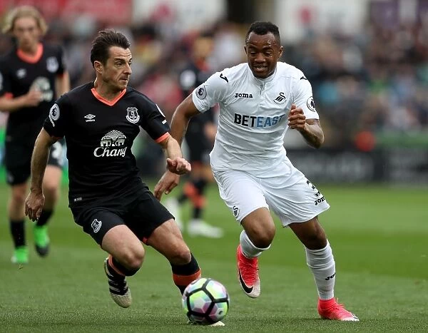 Baines vs. Ayew: Intense Battle for the Ball at Swansea City's Liberty Stadium (Premier League 2016-17)