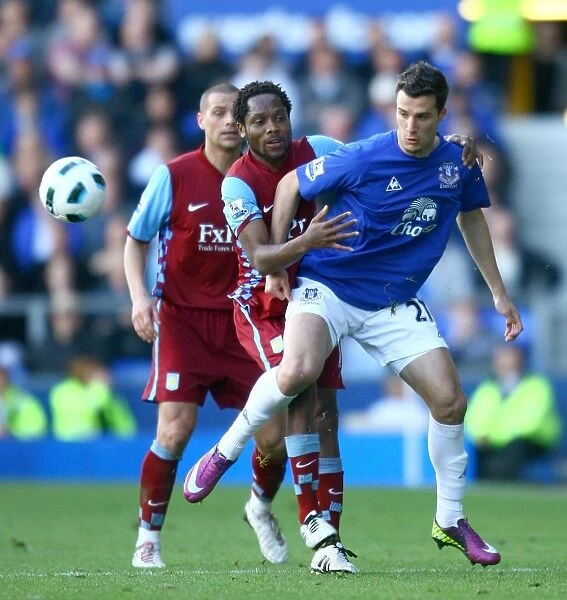 Battle for the Ball: Vellios vs. Makoun - Everton vs. Aston Villa Rivalry in the Barclays Premier League (04 April 2011)