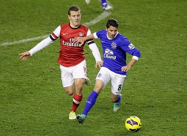 Battle for the Ball: Wilshere vs. Oviedo - Everton vs. Arsenal Rivalry in the Premier League (1-1)