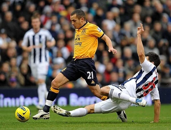 Clash at The Hawthorns: Paul Scharner Tackles Leon Osman (Everton vs. West Bromwich Albion, 01 January 2012)