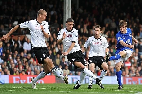 Determined Moment: Seamus Coleman's Striker Under Pressure for Everton Against Fulham (2010, Barclays Premier League, Craven Cottage)
