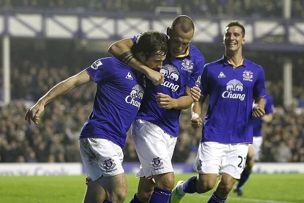 Everton's Baines Scores Penalty, Celebrates with Heitinga and Vellios: A Triumphant Moment at Goodison Park (19 November 2011 vs. Wolverhampton Wanderers)