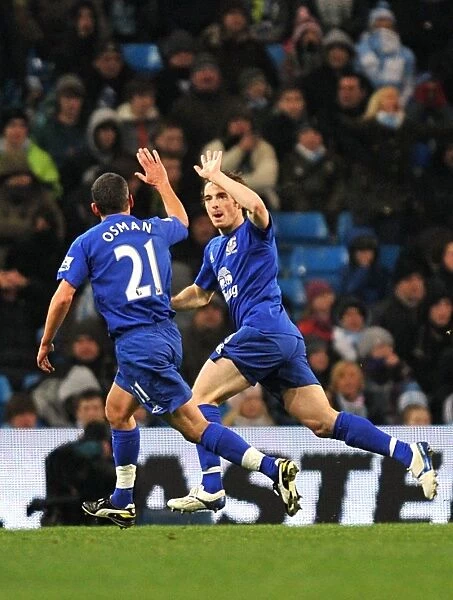 Everton's Double Delight: Baines and Osman Celebrate Second Goal Against Manchester City (2010)