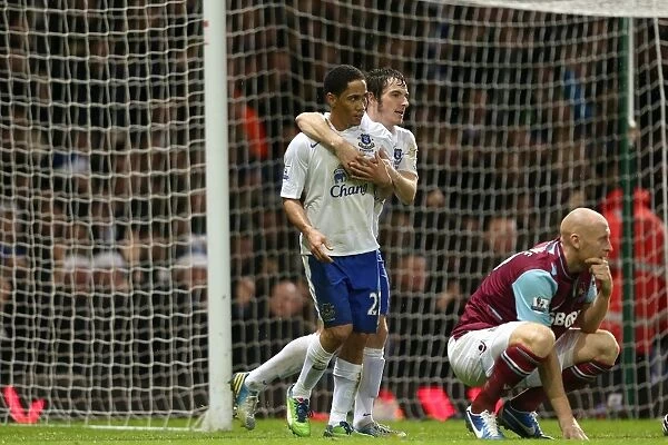 Everton's Double Strike: Pienaar and Baines Celebrate as Collins Looks On in Disappointment (Everton 2-1 West Ham, Upton Park, 2012)