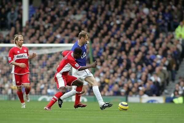 Everton's Ferguson Shields the Ball from Boateng: A Football Intense Moment