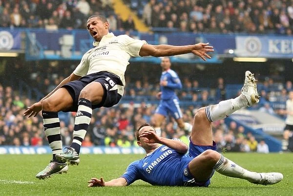 Everton's Jermaine Beckford vs Chelsea's John Terry: A FA Cup Battle at Stamford Bridge - Determined Striker vs Defiant Captain (February 19, 2011)