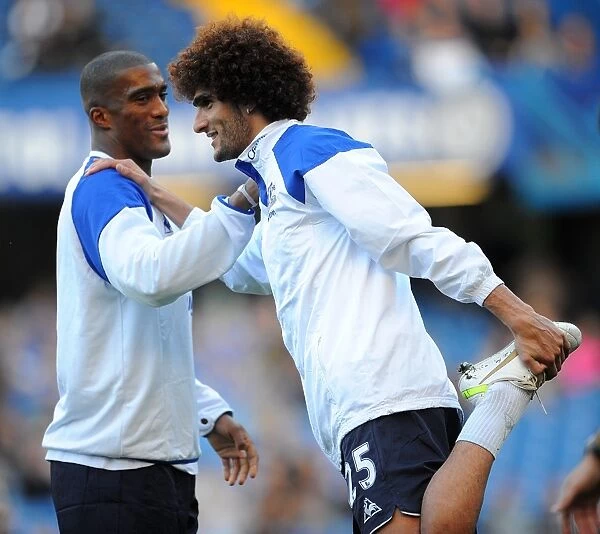 Everton's Unyielding Duo: Distin and Fellaini in Focus at Stamford Bridge before the Chelsea Showdown (Barclays Premier League, 15 October 2011)