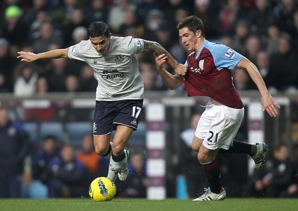 Intense Battle for Ball Possession: Tim Cahill vs. Ciaran Clark - Everton vs. Aston Villa (Premier League, 2012)