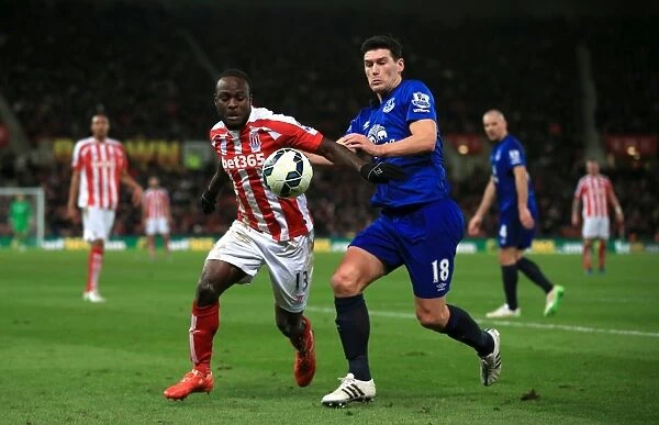 Intense Battle for Possession: Gareth Barry (Everton) vs. Victor Moses (Stoke City) in the Barclays Premier League
