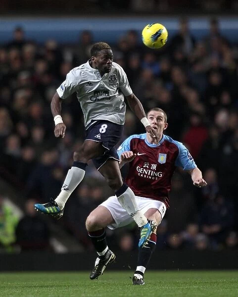 Intense Battle: Saha vs Dunne - Everton vs Aston Villa, Premier League (2012): A Clash of Titans at Villa Park