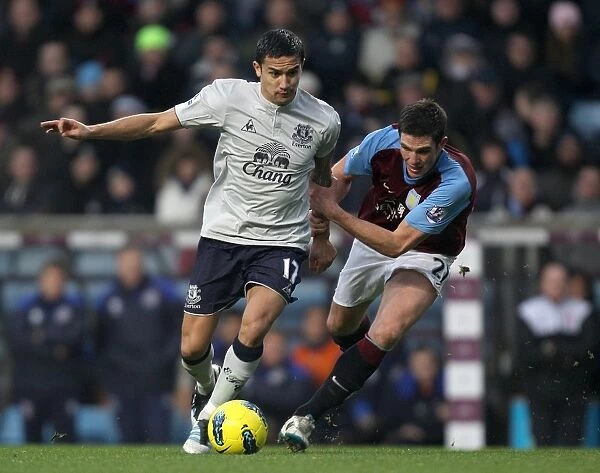 Intense Premier League Showdown: Tim Cahill vs. Ciaran Clark - Battle for Ball Possession (2012, Aston Villa vs. Everton)