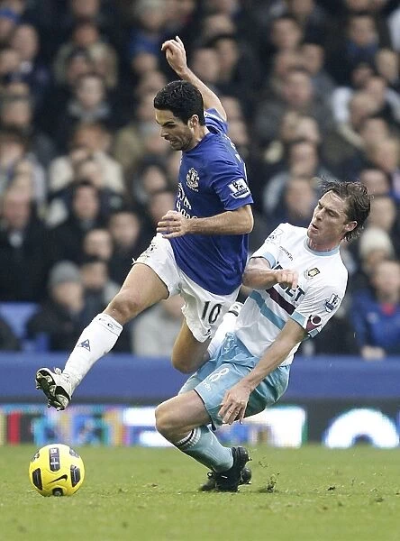 Intense Rivalry: Arteta vs. Parker - A Battle for Ball Possession (Everton vs. West Ham United, Barclays Premier League, 2011)