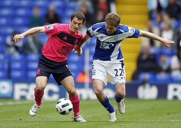 Intense Rivalry: Baines vs. Hleb Battle for Ball at St. Andrews, October 2010