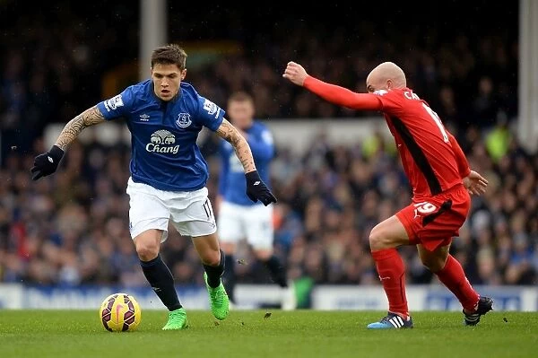 Intense Rivalry: Besic vs. Cambiasso Battle for Ball at Goodison Park - Everton vs. Leicester City, Premier League