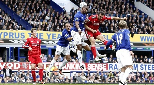 Intense Rivalry: Distin vs. Kyrgiakos Aerial Battle in the Everton vs. Liverpool Premier League Clash (October 2010)