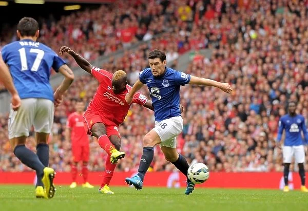 Intense Rivalry: Gareth Barry Blocks Mario Balotelli's Goal-bound Shot - Liverpool vs. Everton, Premier League