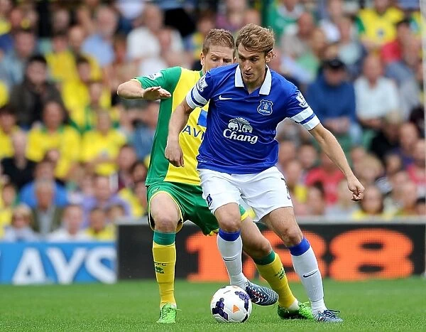 Intense Rivalry: Jelavic vs Turner's Battle for Ball in Everton's Draw with Norwich City (BPL 2013)