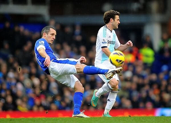 Leon Osman vs Juan Mata: Intense Battle for Ball Possession in Everton vs Chelsea Premier League Clash (December 30, 2012)