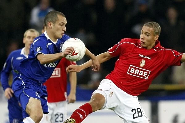 Osman vs. Witsel: Battle in the UEFA Cup - Everton's Leon Osman Clashes with Standard Liege's Axel Witsel