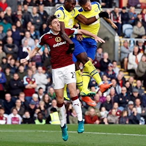 Clash at Turf Moor: Jagielka and Bolasie Battle Ward for Ball Control in Everton vs Burnley Premier League Encounter