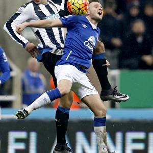 Intense Rivalry: Mitrovic vs. Cleverley Battle for Ball in Newcastle United vs. Everton Premier League Clash