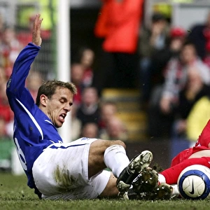 Phil Neville vs Luis Garcia: Intense Tackle on the Football Field