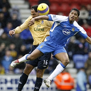Wigan Athletics Valencia challenges Evertons Lescott for the ball during their English Premier Lea