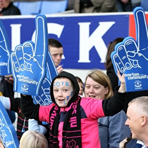 Young Everton Fan's Thrill: Half-Time Excitement at Goodison Park with Giant Foam Hands (Everton vs Stoke City, Barclays Premier League, 2010)
