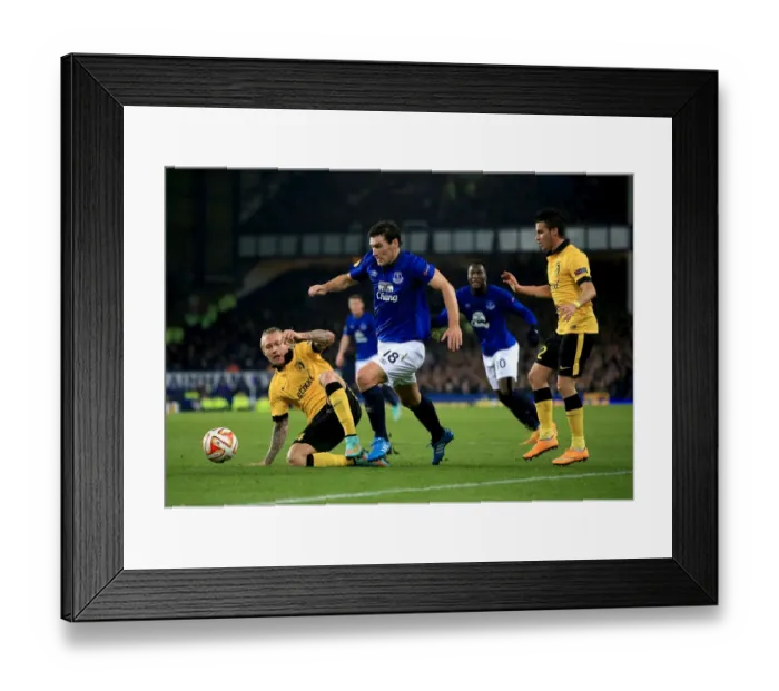 Framed Print : Gareth Barry vs. Simon Kjaer: A Battle for the Ball in Everton vs. Lille UEFA Europa League Clash Framed Print : Gareth Barry vs. Simon Kjaer: A Battle for the Ball in Everton vs. Lille UEFA Europa League Clash
