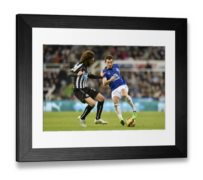 Framed Print : Coloccini vs. Baines: Intense Clash Between Newcastle's Fabricio Coloccini and Everton's Leighton Baines in Premier League Encounter Framed Print : Coloccini vs. Baines: Intense Clash Between Newcastle's Fabricio Coloccini and Everton's Leighton Baines in Premier League Encounter