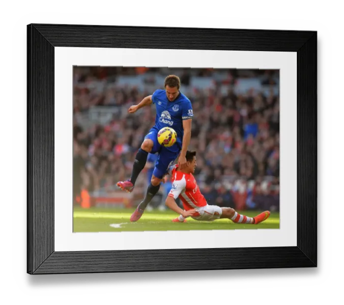 Framed Print : Premier League: Jagielka Tackles Sanchez in Intense Arsenal vs. Everton Clash Framed Print : Premier League: Jagielka Tackles Sanchez in Intense Arsenal vs. Everton Clash