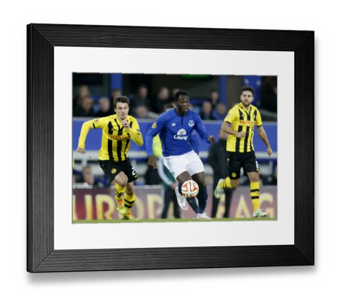 Framed Print : Everton's Lukaku Dazzles with Skillful Dribbles Past Young Boys Defenders in UEFA Europa League Clash at Goodison Park Framed Print : Everton's Lukaku Dazzles with Skillful Dribbles Past Young Boys Defenders in UEFA Europa League Clash at Goodison Park