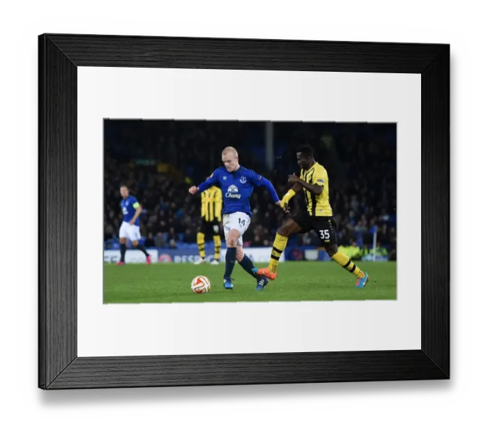 Framed Print : Everton's Naismith Slips Past Young Boys Sanogo in Europa League Showdown at Goodison Park