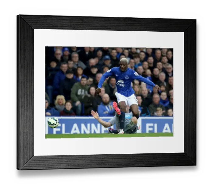 Framed Print : Arouna Kone vs Ryan Taylor: Intense Clash between Everton and Newcastle United in Barclays Premier League at Goodison Park