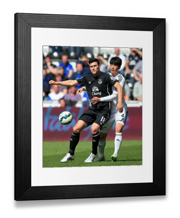 Framed Print : Intense Rivalry: Gareth Barry vs. Ki Sung-Yueng Battle at Swansea City vs. Everton (Premier League) Framed Print : Intense Rivalry: Gareth Barry vs. Ki Sung-Yueng Battle at Swansea City vs. Everton (Premier League)