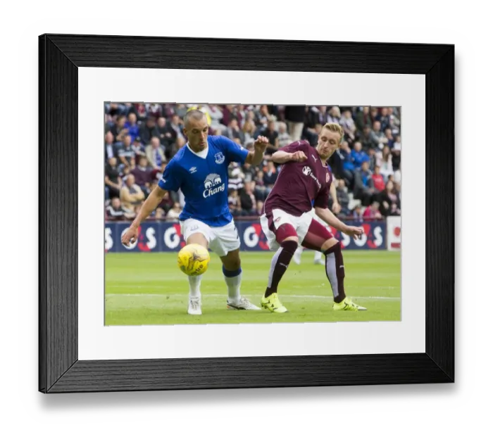 Framed Print : Osman vs. McKirdy: A Battle for the Ball in Everton's Pre-Season Clash at Tynecastle Stadium Framed Print : Osman vs. McKirdy: A Battle for the Ball in Everton's Pre-Season Clash at Tynecastle Stadium