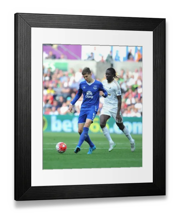 Framed Print : Swansea's Eder Clashes with Everton's John Stones in Intense Barclays Premier League Match Framed Print : Swansea's Eder Clashes with Everton's John Stones in Intense Barclays Premier League Match