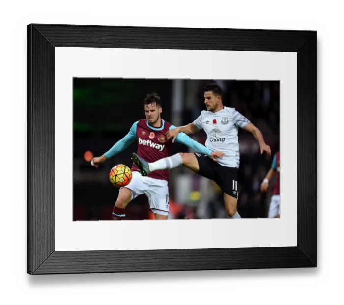 Framed Print : Intense Rivalry: Jenkinson vs. Mirallas at Upton Park - West Ham United vs. Everton Premier League Clash Framed Print : Intense Rivalry: Jenkinson vs. Mirallas at Upton Park - West Ham United vs. Everton Premier League Clash