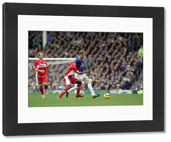 Everton's Ferguson Shields the Ball from Boateng: A Football Intense Moment