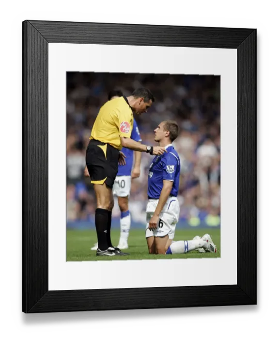 Framed Print : Referee Andre Marriner Confers with Everton's Phil Jagielka during Everton vs Blackburn Rovers, Barclays Premier League (2008)