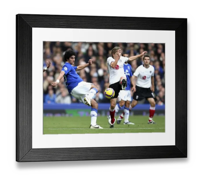 Framed Print : Fellaini vs Bullard: Intense Clash Between Everton's Marouane Fellaini and Fulham's Jimmy Bullard in Premier League Football Framed Print : Fellaini vs Bullard: Intense Clash Between Everton's Marouane Fellaini and Fulham's Jimmy Bullard in Premier League Football