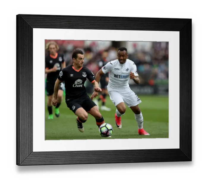 Framed Print : Baines vs. Ayew: Intense Battle for the Ball at Swansea City's Liberty Stadium (Premier League 2016-17)