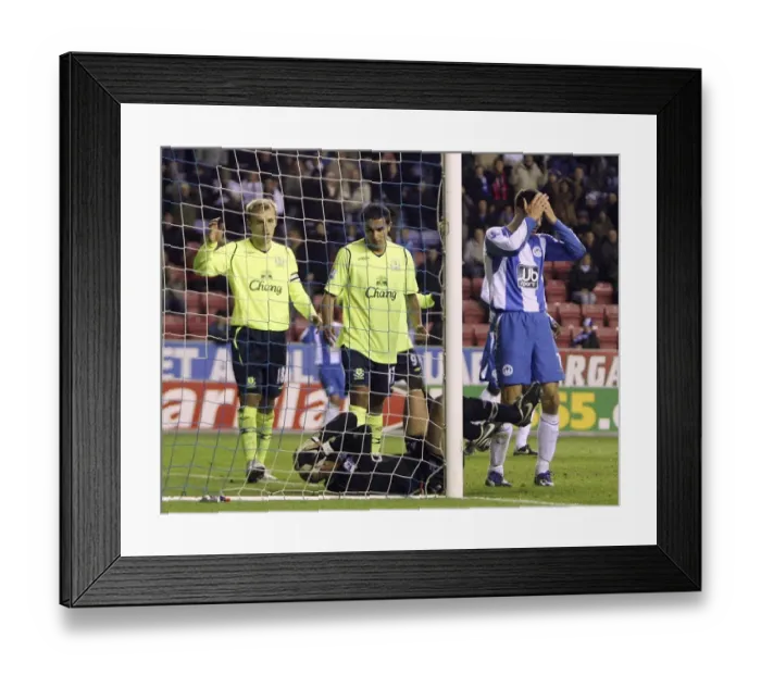 Framed Print : Tim Howard Denies Scharner: Everton's Goalkeeper Saves Wigan Striker's Header in Barclays Premier League Clash Framed Print : Tim Howard Denies Scharner: Everton's Goalkeeper Saves Wigan Striker's Header in Barclays Premier League Clash