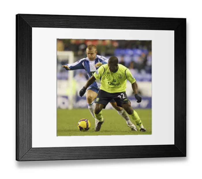 Framed Print : Yakubu vs Cattermole: Intense Clash in Wigan Athletic vs Everton Premier League Match