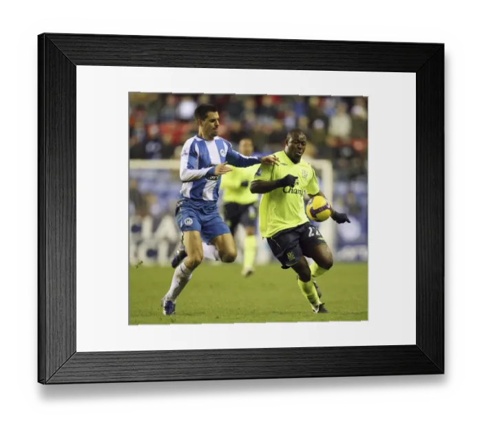 Framed Print : Yakubu vs. Scharner: Intense Clash Between Wigan and Everton in Barclays Premier League Framed Print : Yakubu vs. Scharner: Intense Clash Between Wigan and Everton in Barclays Premier League