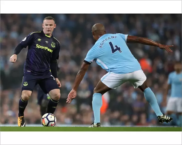 Rooney vs. Kompany: Intense Battle for Ball at Etihad Stadium - Manchester City vs. Everton, Premier League
