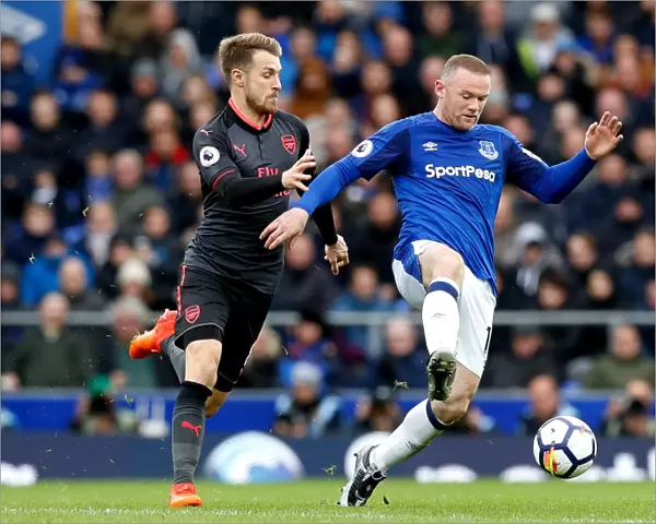 Rooney vs. Ramsey: Intense Battle for the Ball at Goodison Park - Premier League: Everton vs. Arsenal