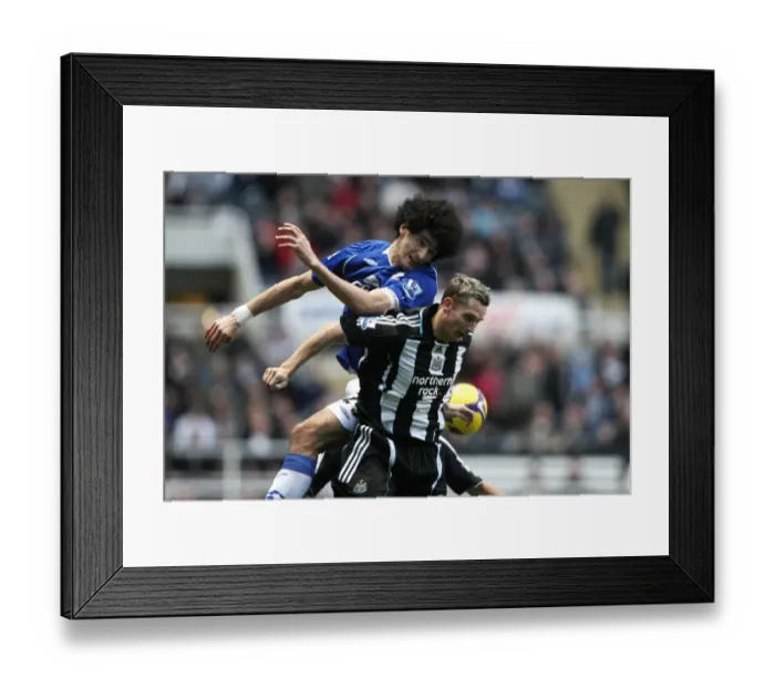 Framed Print : Fellaini vs. Lovenkrands: Intense Rivalry in Premier League Football - Newcastle United vs. Everton Framed Print : Fellaini vs. Lovenkrands: Intense Rivalry in Premier League Football - Newcastle United vs. Everton