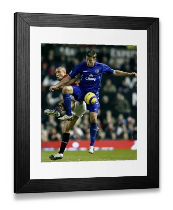 Framed Print : James Beattie vs Mikael Silvestre: A Football Showdown - Beattie Holds Off Silvestre Framed Print : James Beattie vs Mikael Silvestre: A Football Showdown - Beattie Holds Off Silvestre