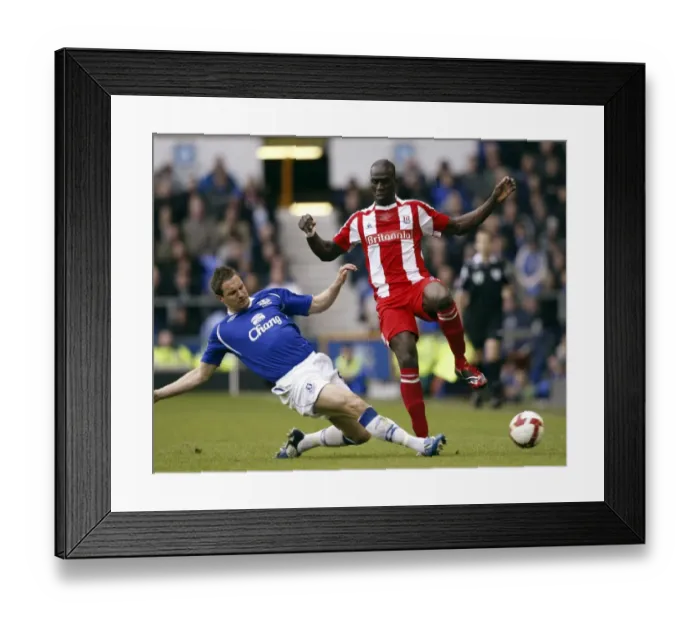 Framed Print : Jagielka vs Sidibe: Intense Clash Between Everton's Jagielka and Stoke's Sidibe in Everton vs Stoke City, Barclays Premier League